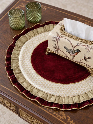Close-up view of Diyaara velvet table mat placed on a wooden console table with an ornate bird-painted tissue box.
