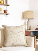 Echo chinoiserie cushion ocver on a sofa with a lamp and shelves in the background