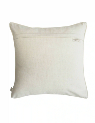 The reverse side view of the Eden cushion cover showing the neat hidden zipper closure system and brand woven tag.