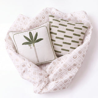 Eka Kanan and Ari gift set: palm and olive stripe cushion covers nestled in Prasanaakshi gift wrap