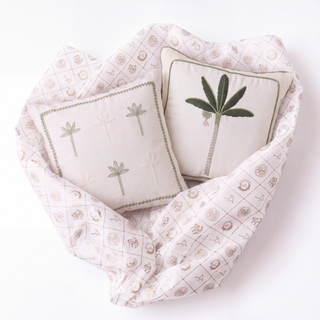 Close-up of the hand-embroidered mini palm sprigs on Botanical Stitch beside the bold thread-painted palm on Eka Kanan.