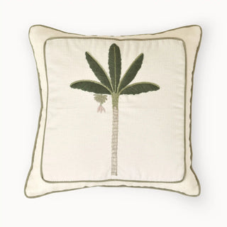 A top-down view of the Eka Kanan cushion showcasing the central hand-embroidered palm motif on an ivory base.