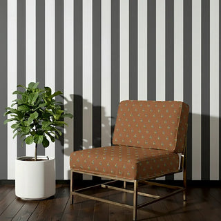 Ekani Sofa and Chair Upholstery Fabric in earthy brown with subtle floral motifs, styled on a lounge chair.