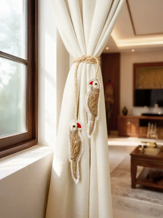 Ranjha Parrot tieback used in a warm, luxury living room setting next to a sunlit window.