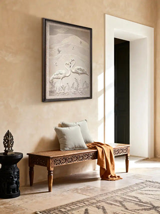 Sculpted Song flamingo print displayed above a wooden bench in a serene, beige-toned hallway.