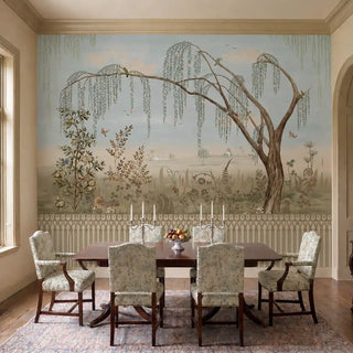 Enchanted Grove customised wallpaper with parakeets in a willow tree above a low cream daybed and a slim wooden side table in a minimal living room