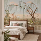The Enchanted Grove multicolor wallpaper mural with a weeping willow and birds behind a walnut bed with a linen headboard and rattan nightstands in a bedroom view-bedroom