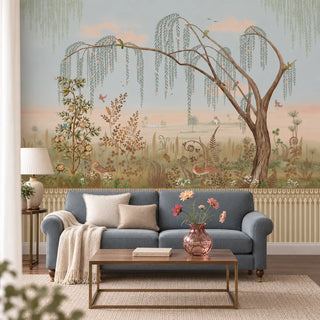 The Enchanted Grove multicolor wallpaper mural with a weeping willow, birds and ferns behind a grey sofa and brass coffee table in a living room view-livingroom