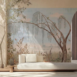 The full-scale Enchanted Grove tropical wetland wallpaper styled elegantly behind a low cream sofa in a bright, sun-drenched modern lounge hall.