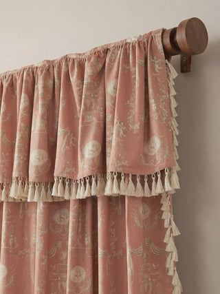 Close-up of the ruffled curtain valance with double-layered tassel fringe mounted on a dark wooden rod.