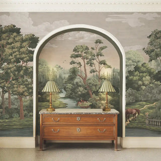 Wooden dresser with marble top in front of a large mural of a landscape with trees and a river.