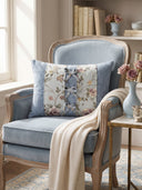 The Eternal Garden Blue Bow lumbar cushion styled on a cream sofa as a central decorative accent.