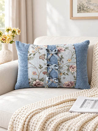 The Eternal Garden Blue Bow lumbar cushion styled on a cream sofa as a central decorative accent.