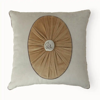 A lifestyle view of the Florence cushion cover styled on a light-colored armchair next to a draped linen throw.