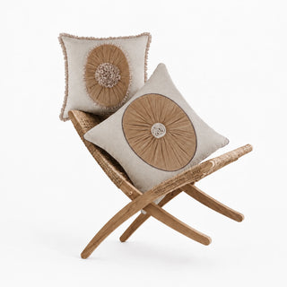 Florence Pleated Rosette and Frieze cushion covers on a rattan folding chair, camel velvet sunbursts on ivory