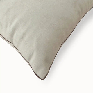 A close-up detail showing the premium velvet texture and contrast brown piping on the edge of the Florence cushion.