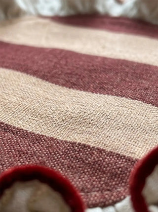 Macro texture shot of Florentine Ruffles revealing the woven striped pattern in maroon and cream with dimensional ruffled border detail.