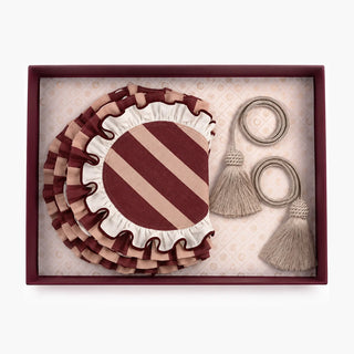 The Florentine Table Mats & Tieback Gift Set in Burgundy & Blush, showing striped ruffled mats and tasselled cord tiebacks in an open box.