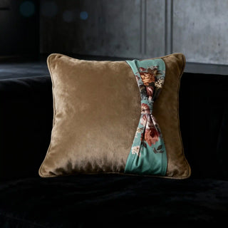 Single Florid Belle Knot Cushion displayed on a black velvet sofa in a dramatic setting.
