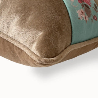 Close-up of the tawny velvet cushion corner showing the smooth piping finish.