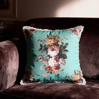 Single Florid Rosette Cushion Cover displayed on a maroon velvet sofa in a rich setting.