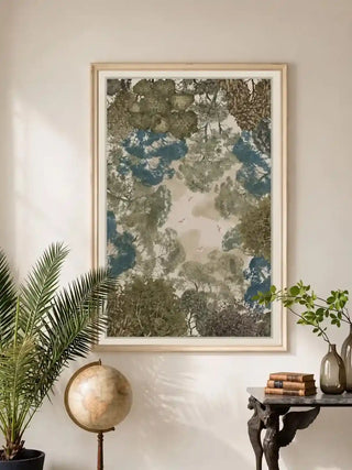 Framed The Forest Nest wall art with a canopy view and birds hanging above a marble side table in a neutral living room