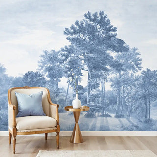 Full wall installation of the Forest Song blue and white scenic forest mural in a living room.