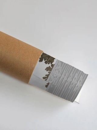 Premium protective packaging tube showing the rolled French Life art print and its ornate grey border detail.