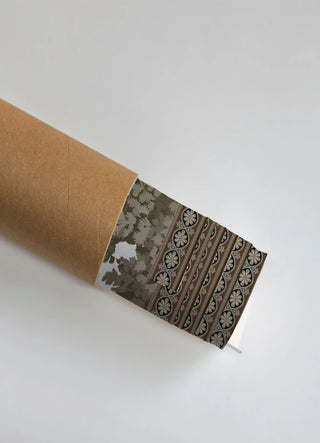 The French Life wall art print partially unrolled from its kraft paper shipping tube, showing a tonal foliage silhouette field beside a striped rosette medallion border in grey, black and brown.