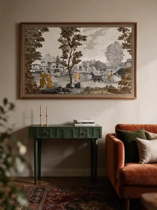 The French Life wall art, landscape orientation, framed above a green console table beside a rust velvet sofa.