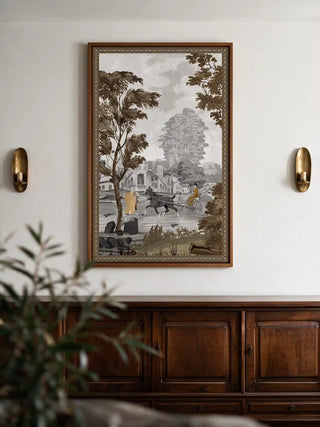 The French Life wall art framed above a dark wood cabinet with brass wall sconces.