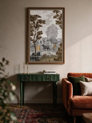 The French Life wall art framed above a green console table beside a rust velvet sofa.
