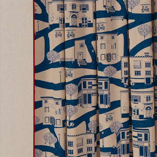 A detailed shot of the French Town Pipin curtain fabric, showing the intricate details of the illustrated town scene up close.