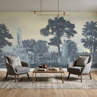A luxury living room featuring the Garden Charm Blue mural behind grey velvet armchairs and a modern coffee table.