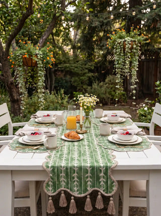 The Garden Gala table runner providing a palatial botanical highlight down the center of a rustic wooden formal dining layout.