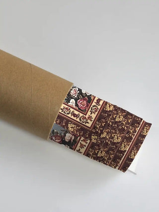 Garden of Tunes wall art securely packaged and emerging from a premium rolled shipping tube