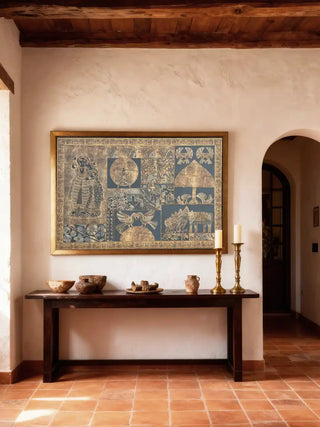 The Geet Madhubani design displayed in a gold frame above a dark wood console table in an elegant foyer