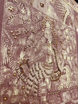 A detailed close-up of the Geet Madhubani embroidered wall art highlighting a figure outlined in sequins and gold beads against fine patterned line work