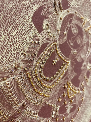 High-resolution close-up showing the intricate gold beadwork and metallic sequins on the divine figures in Geet Madhubani.