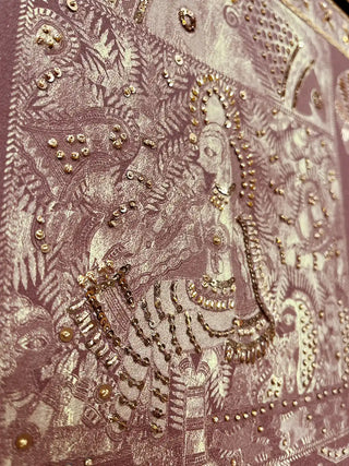 A close-up highlighting the tactile gold embroidery and shimmering sequin details on the rust-colored background