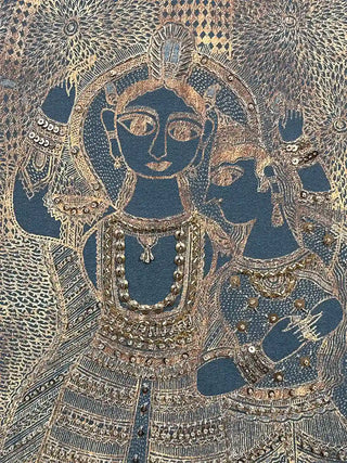 Close-up showing the rich, tactile embroidery texture and golden linework of the central human figures