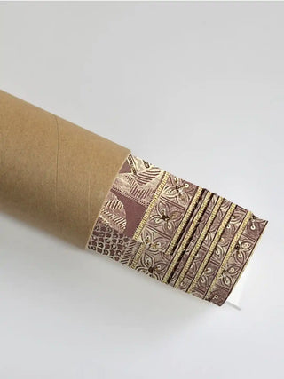 A section of the Geet Madhubani art showing the rust pattern detail partially unrolled from its protective shipping tube.