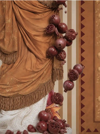 Texture close-up of the Gilded Mythos wall art in amber ochre, showing the fringed golden drapery and a cascade of pomegranates falling across striped panelling.