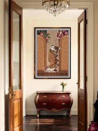 Framed Gilded Mythos wall art in amber ochre above an antique red bombé chest, lit by a crystal chandelier in a classic entryway.