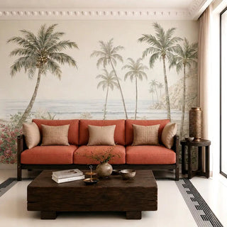 The Goa Coastal Romance tropical scenic wallpaper mural installed as a main feature wall behind a terracotta sofa in a modern living room.