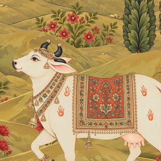 A detailed close-up of the Gokul Reverie wallpaper showing a white cow with a jewelled harness, bells and a floral saddle cloth on olive hills