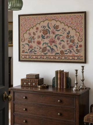 The Golestan wall art landscape framed above a dark wood chest of drawers, styled with vintage boxes, books and silver candlesticks.
