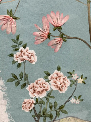 A detailed macro close-up of the Grace Embrace embroidered wall art showing pink petals and pink blooms with raised thread stitching and stitched green leaves.