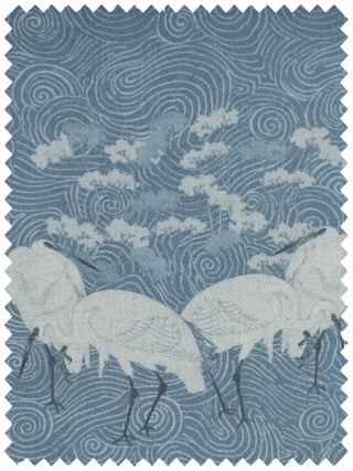 A high-resolution flat lay swatch of the Graceful Cranes linen fabric showing white cranes on a blue swirled water pattern.