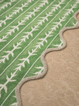 A high-resolution close-up detail of the Green Gala table runner highlighting its block-printed leaf tracks and neat scalloped piping edge.